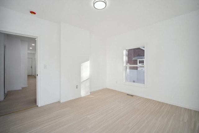 unfurnished room with light wood-type flooring