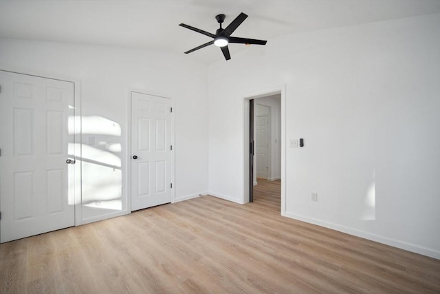 unfurnished bedroom with ceiling fan, lofted ceiling, and light wood-type flooring