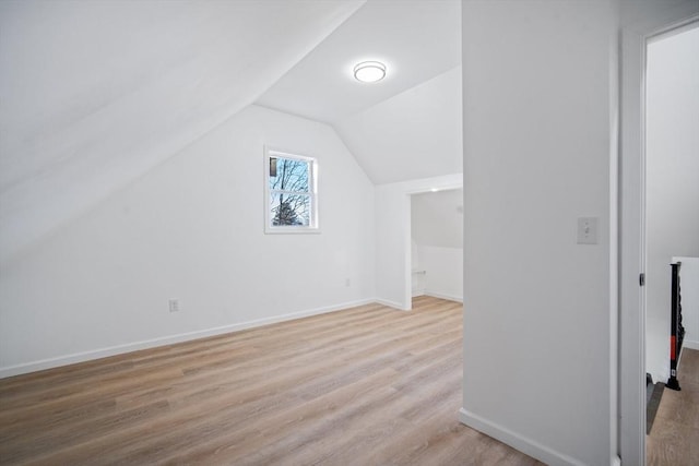 bonus room with lofted ceiling and light hardwood / wood-style floors