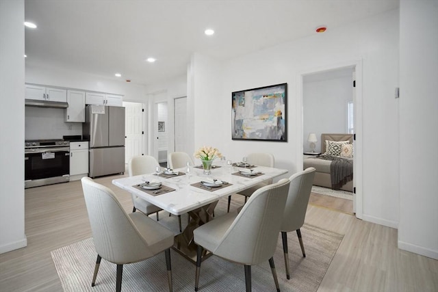 dining space with light wood-type flooring