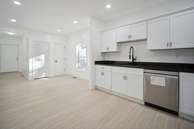 kitchen featuring dishwasher, sink, white cabinets, and light wood-type flooring