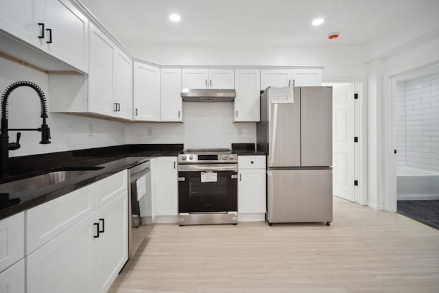 kitchen featuring white cabinetry, stainless steel appliances, light hardwood / wood-style floors, and sink