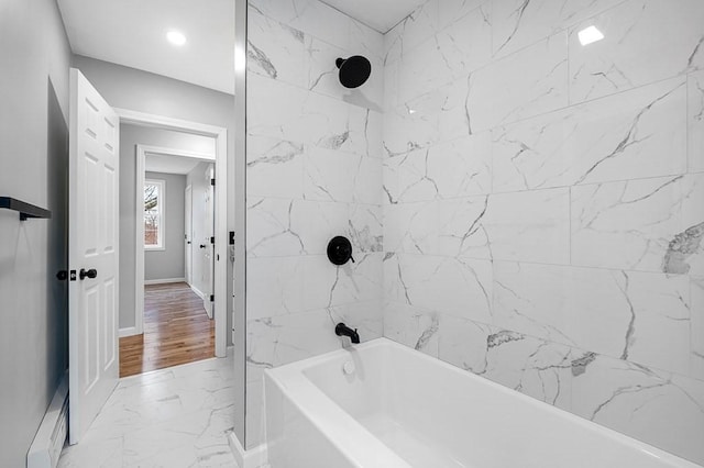 full bathroom featuring marble finish floor, shower / bathing tub combination, and baseboards