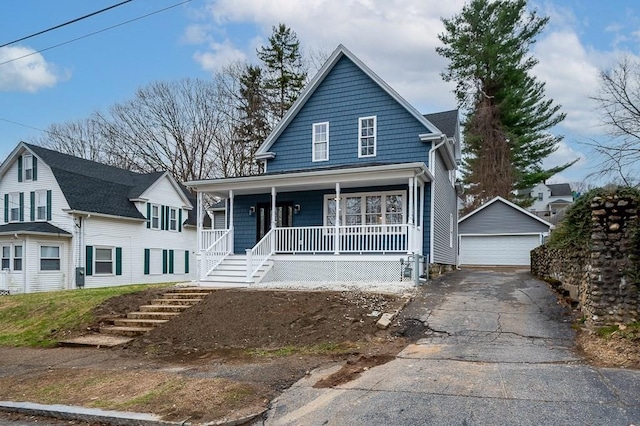 view of front of house featuring a detached garage, an outbuilding, and covered porch
