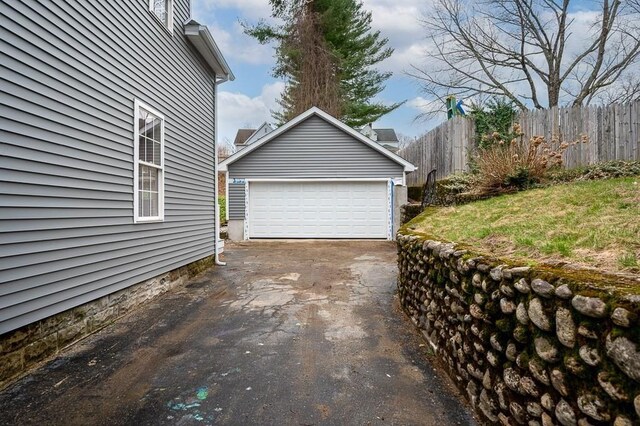 detached garage featuring fence