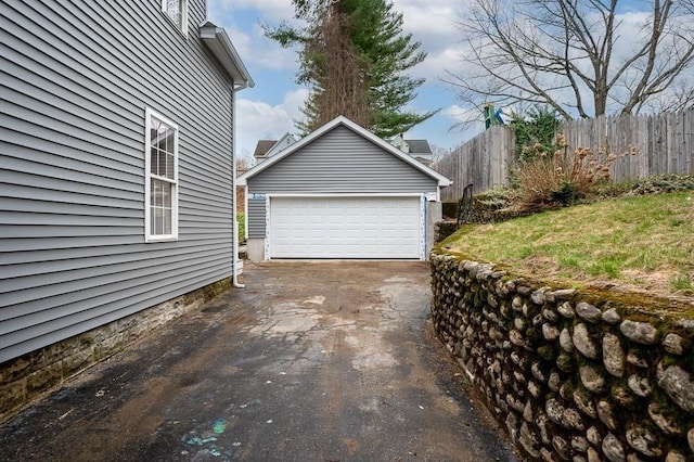 detached garage featuring fence