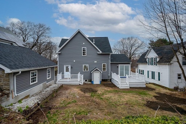 back of house with a deck