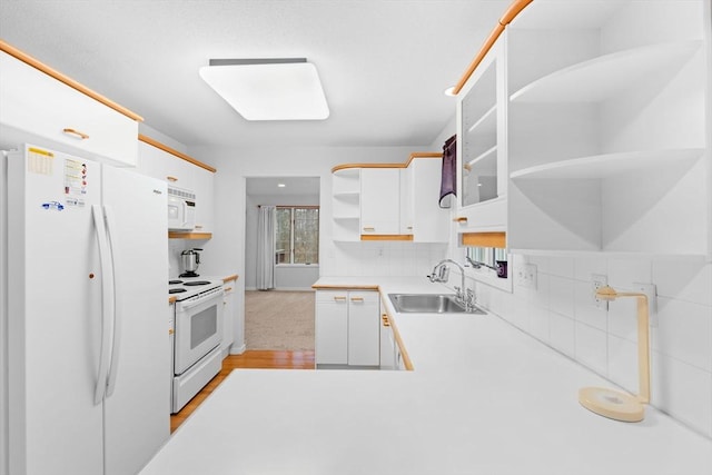 kitchen with open shelves, white appliances, a sink, and white cabinets