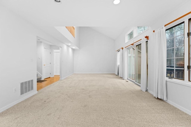 unfurnished room with visible vents, baseboards, lofted ceiling, carpet, and recessed lighting