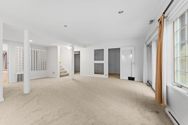 interior space featuring carpet, a baseboard radiator, stairs, and visible vents