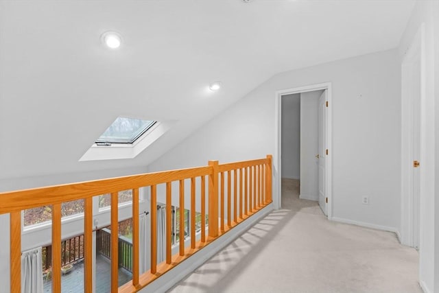 additional living space with lofted ceiling with skylight, carpet flooring, and baseboards