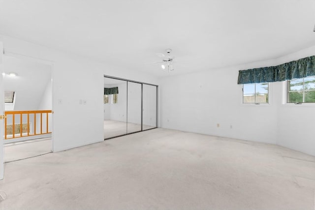 unfurnished bedroom featuring a ceiling fan and a closet