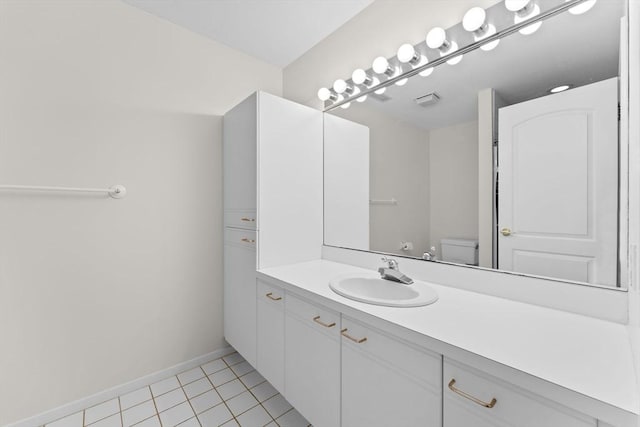 bathroom with toilet, visible vents, baseboards, vanity, and tile patterned floors