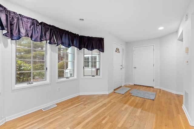 foyer entrance featuring recessed lighting, visible vents, baseboards, and wood finished floors