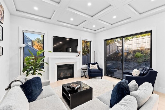 living room with a premium fireplace, beamed ceiling, and coffered ceiling