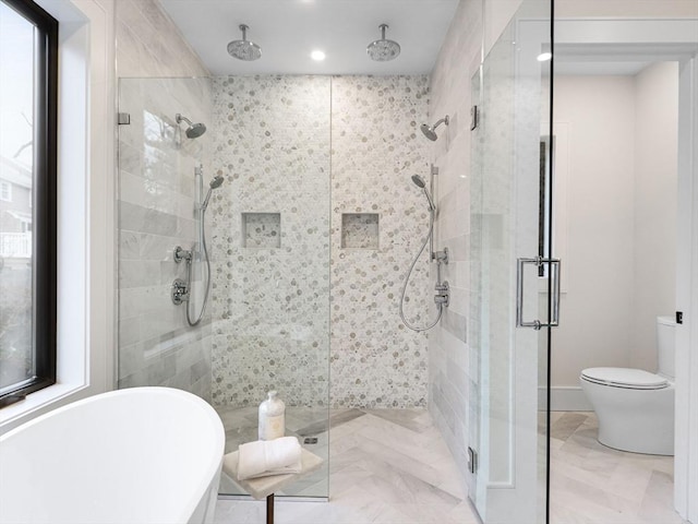 bathroom featuring separate shower and tub and toilet