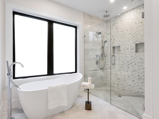 bathroom with separate shower and tub and plenty of natural light