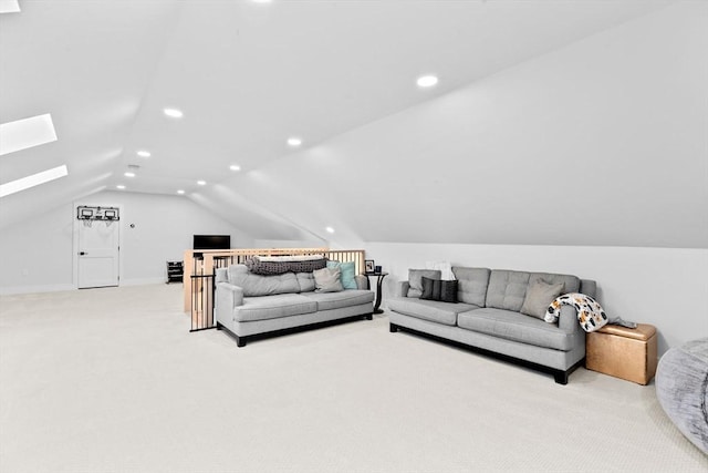 carpeted living room with vaulted ceiling with skylight