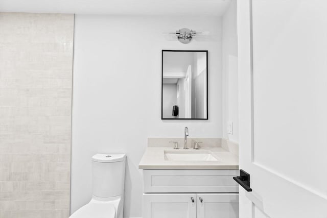 bathroom featuring vanity and toilet