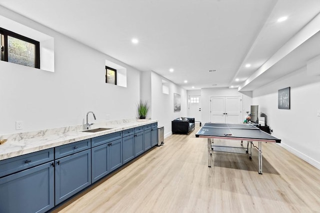 game room with sink and light wood-type flooring