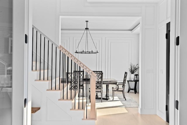 dining room with wood-type flooring and an inviting chandelier