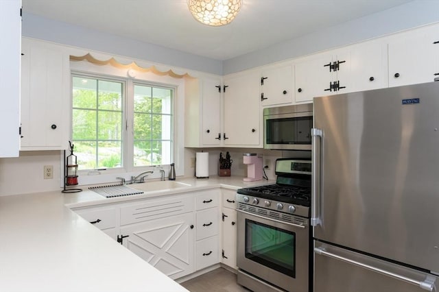 5 Indian Hl, Beverly, MA 01915 - kitchen with stainless steel appliances, light countertops, white cabinetry, and a sink