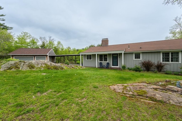 5 Indian Hl, Beverly, MA 01915 - back of house featuring a chimney, board and batten siding, a detached garage, a lawn, and an outbuilding