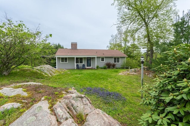 5 Indian Hl, Beverly, MA 01915 - back of property with a chimney and a yard