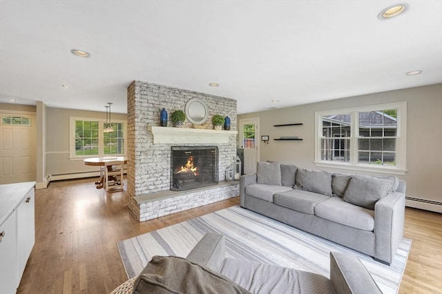 5 Indian Hl, Beverly, MA 01915 - living room with baseboard heating, a fireplace, wood finished floors, and recessed lighting