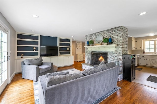 5 Indian Hl, Beverly, MA 01915 - living area featuring a brick fireplace, light wood-style floors, and recessed lighting
