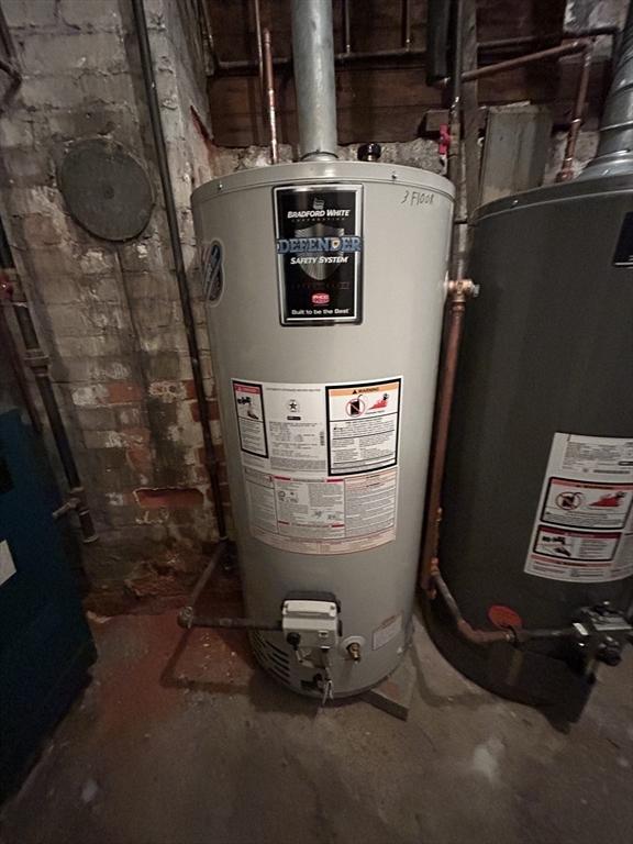 utility room featuring water heater