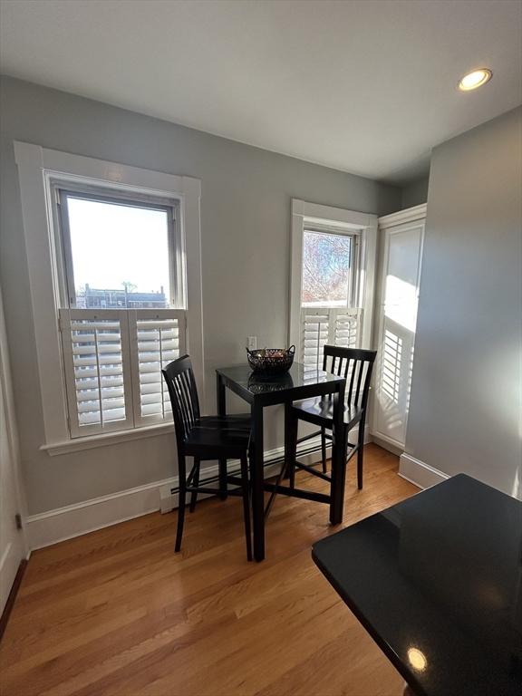 dining area with a healthy amount of sunlight, light wood finished floors, and baseboards