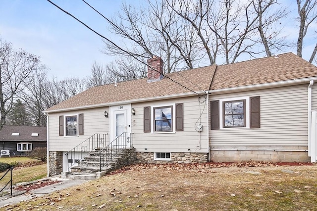 view of front of home featuring a shingled roof and a chimney