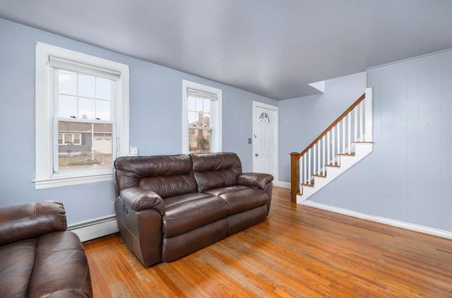 living room featuring baseboard heating and wood-type flooring