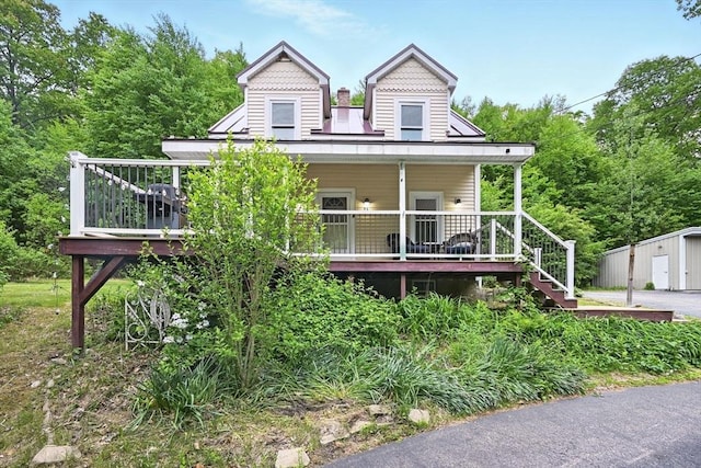 24 Barnett Rd, Sutton, MA 01590 - view of front facade with stairs, a porch, and an outdoor structure