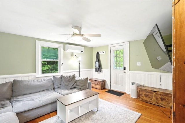 24 Barnett Rd, Sutton, MA 01590 - living area with wainscoting, ceiling fan, a wall mounted air conditioner, and wood finished floors