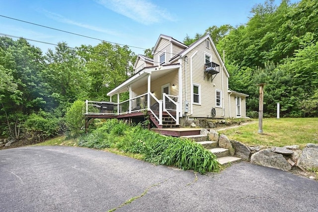 24 Barnett Rd, Sutton, MA 01590 - view of front facade with a deck and a front lawn