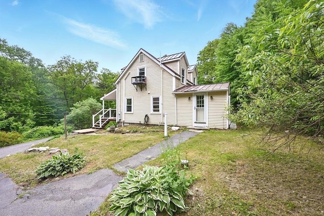 24 Barnett Rd, Sutton, MA 01590 - rear view of property with a standing seam roof, metal roof, and a lawn