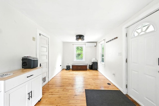 24 Barnett Rd, Sutton, MA 01590 - entryway featuring light wood finished floors and an AC wall unit