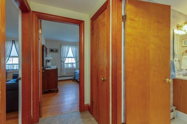 hall with baseboard heating and plenty of natural light