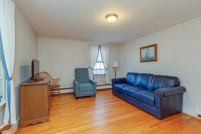 living room featuring a baseboard heating unit and light wood-type flooring