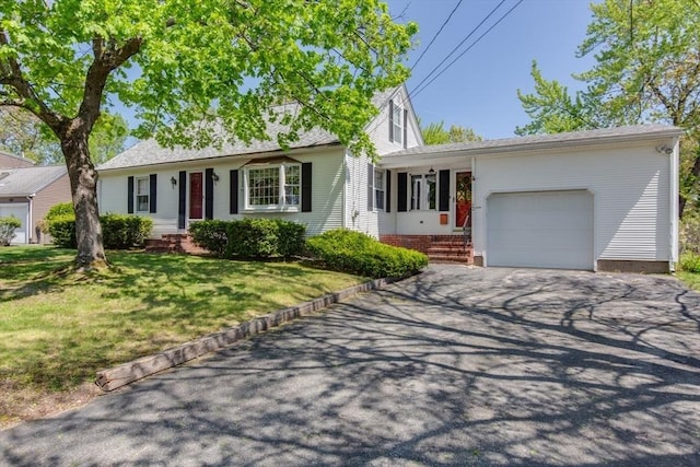 ranch-style house with asphalt driveway, an attached garage, and a front lawn