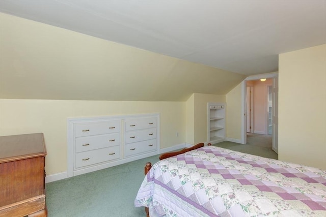 carpeted bedroom with lofted ceiling and baseboards