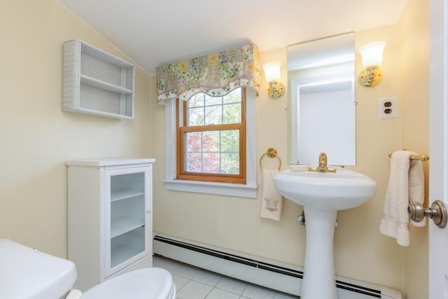 bathroom with toilet, tile patterned floors, and a baseboard heating unit