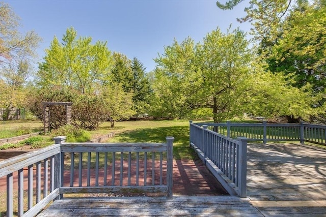 wooden terrace featuring a lawn