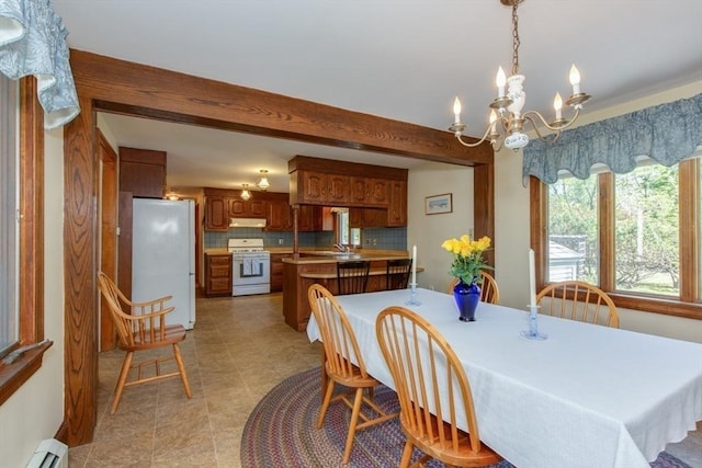 dining room featuring baseboard heating and a chandelier