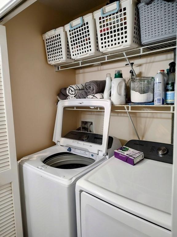 clothes washing area with washing machine and clothes dryer