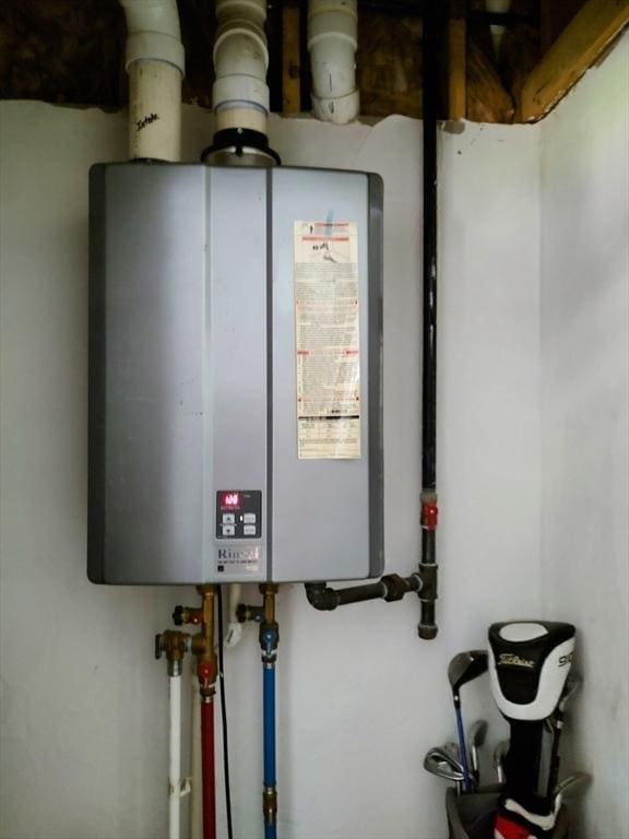utility room featuring water heater