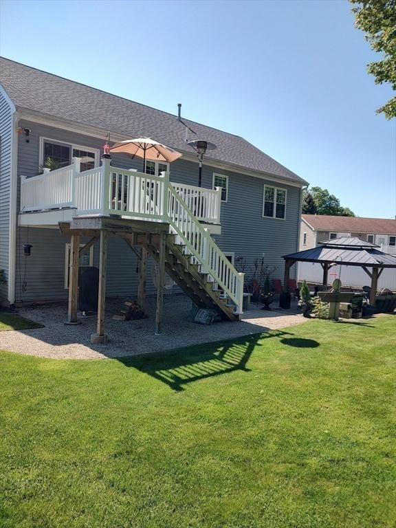 back of house with a gazebo, stairs, a yard, a deck, and roof with shingles