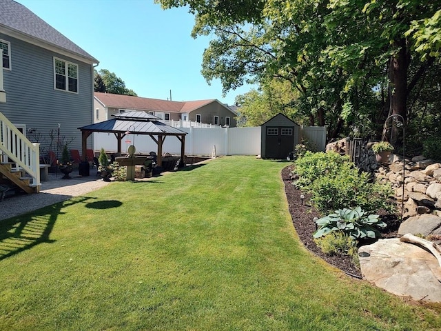 view of yard with a gazebo, a shed, an outbuilding, and stairway